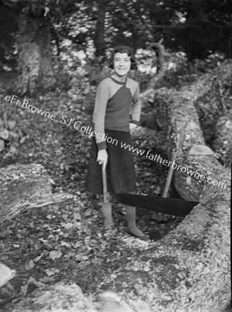 WOMAN AT SAW IN FOREST